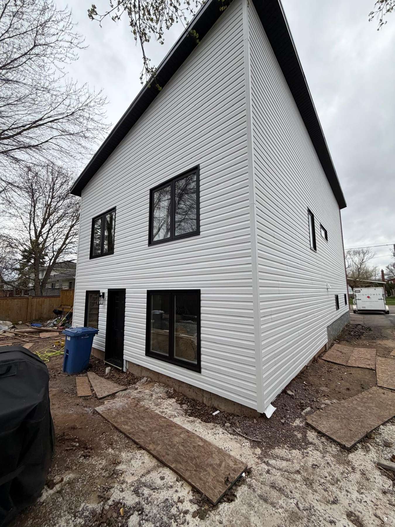 A rust-toned accent wall and new attached garage on a completed second-storey addition