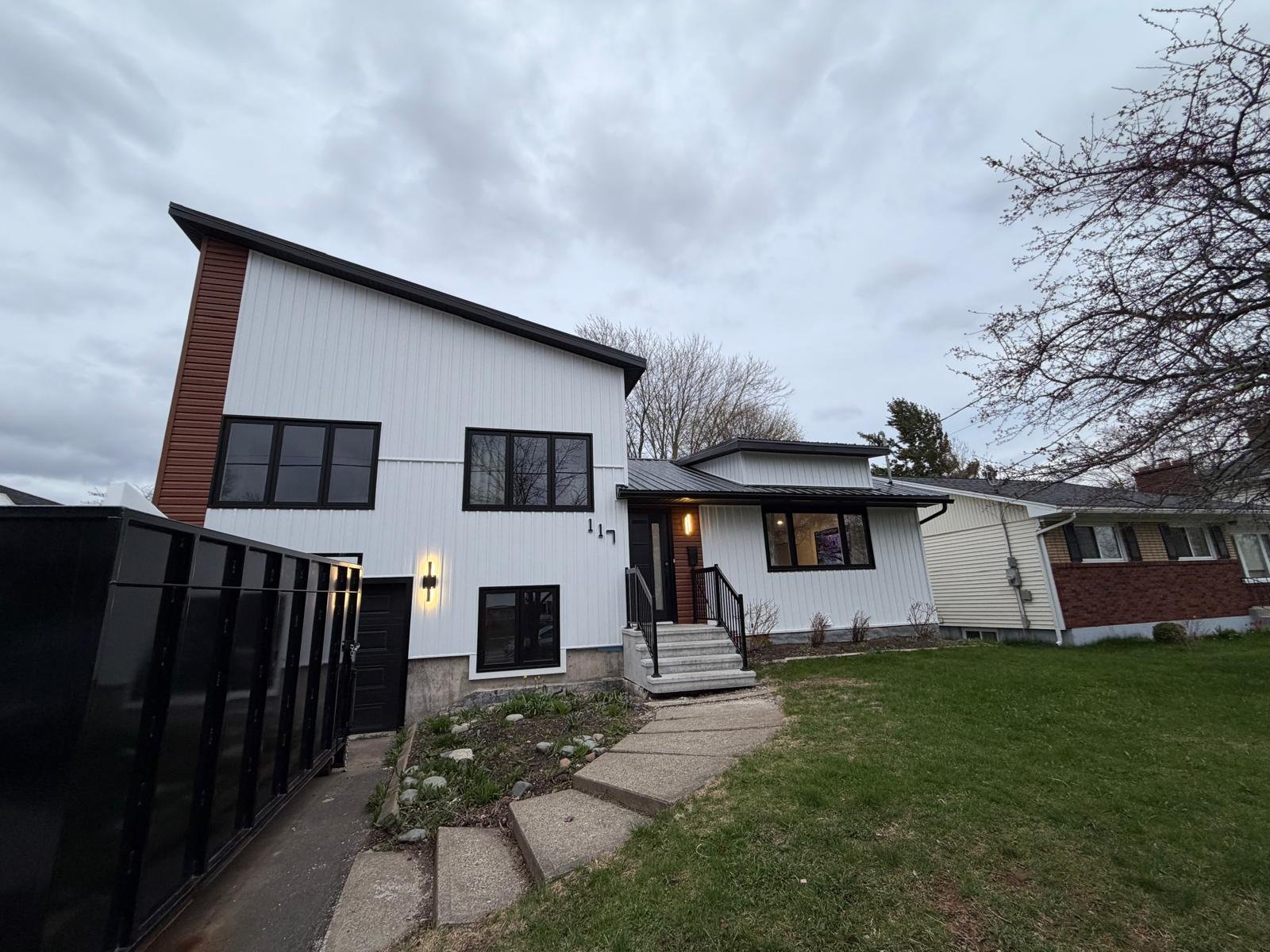 A completed second-storey addition, front elevation at dusk