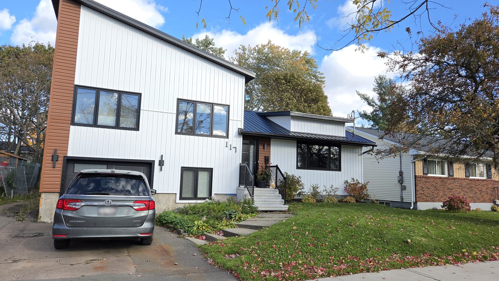 The completed addition seen from the driveway, with the new attached garage