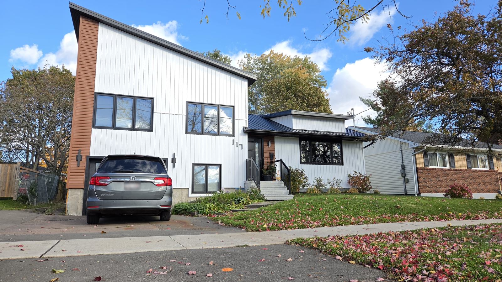 Front elevation of the finished home with the garage and covered entry