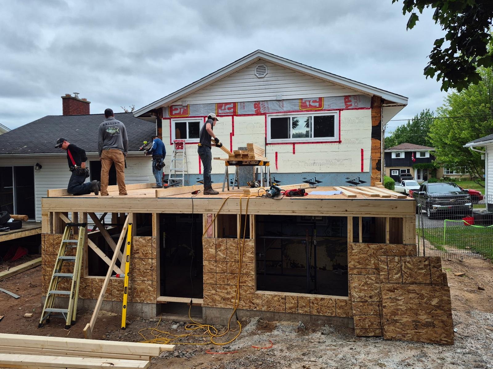 New second-storey floor and wall framing being built over an existing single-storey home