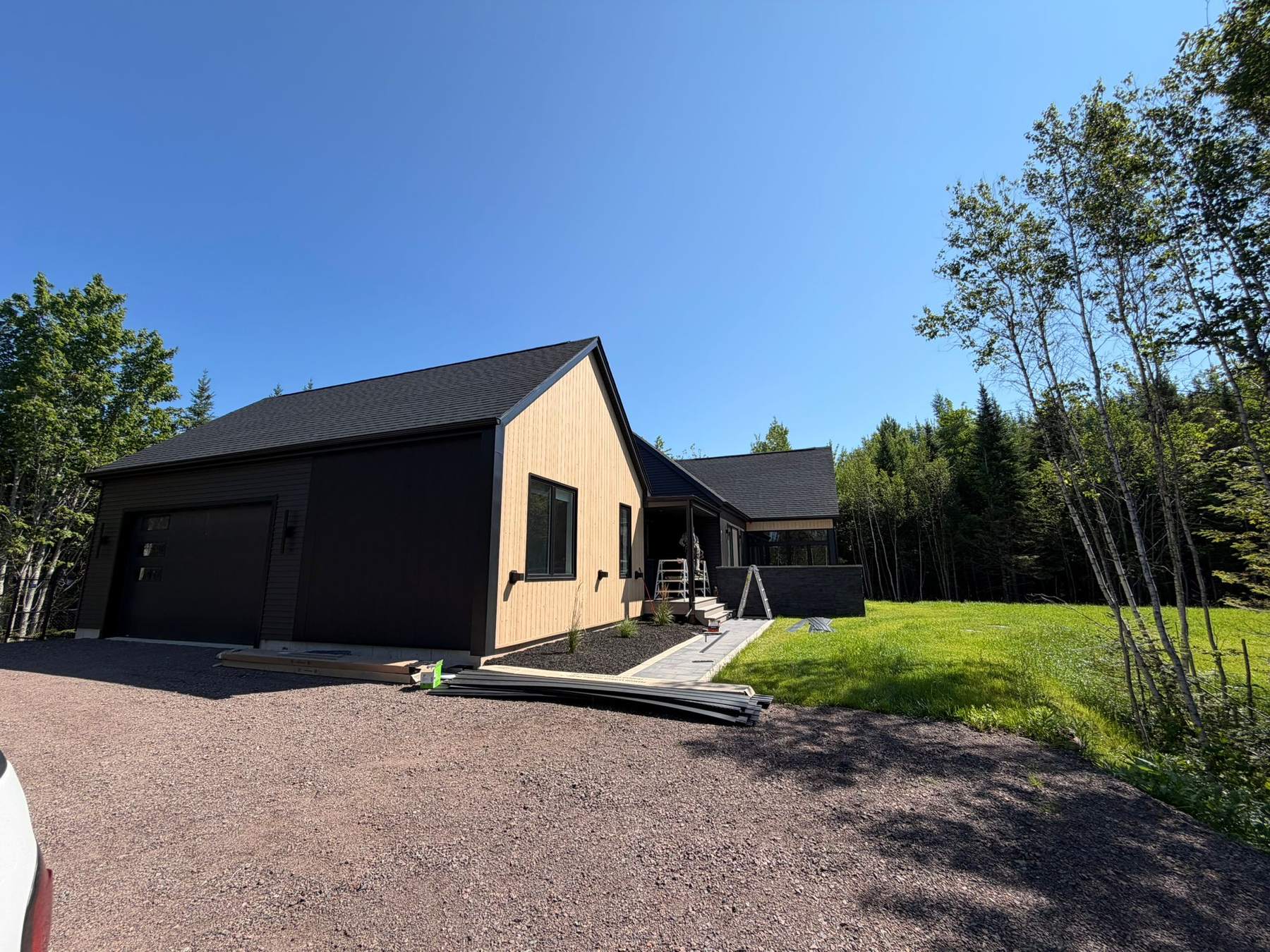 The finished home from the driveway with landscaping complete