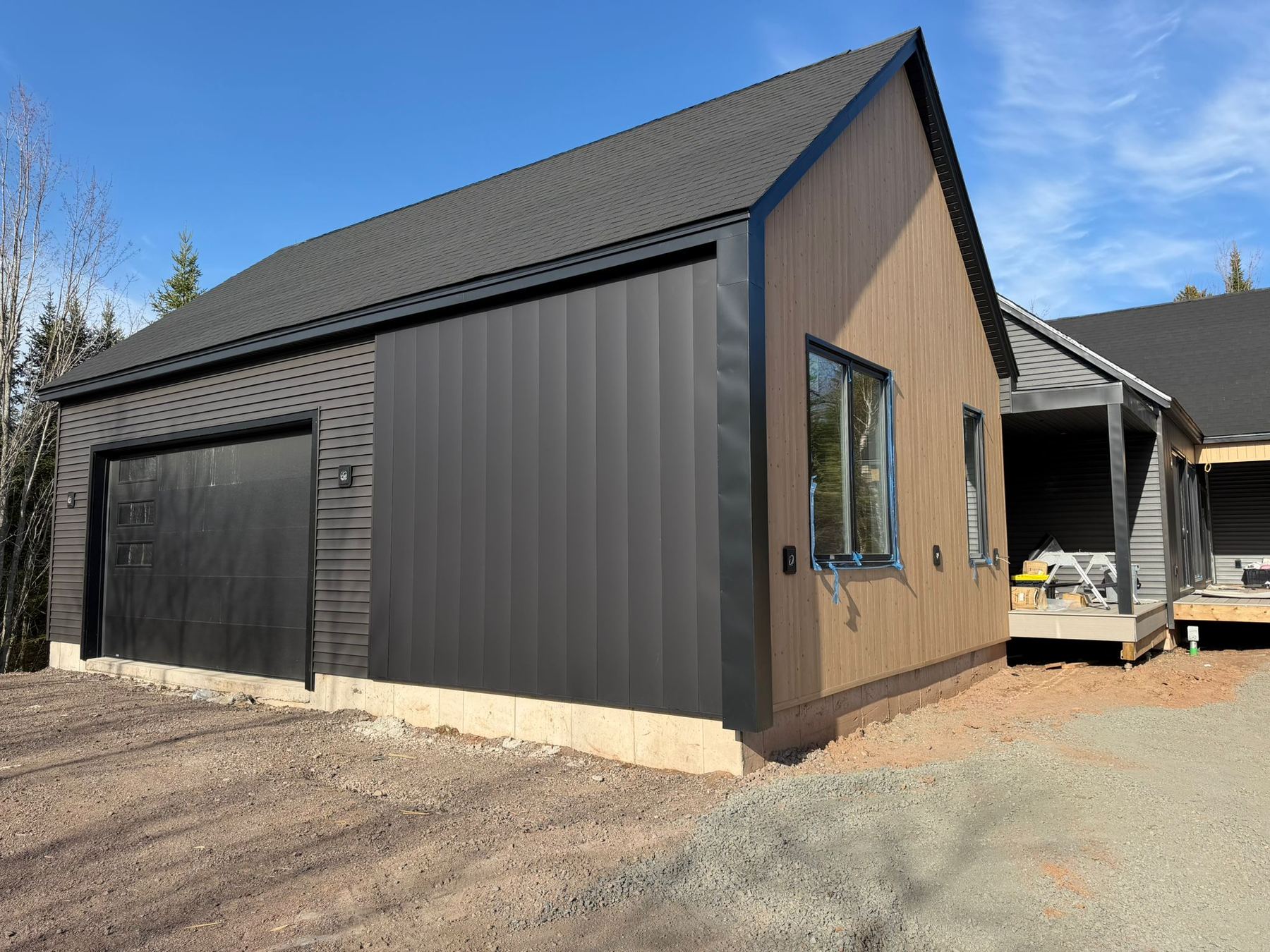 Finished garage with dark cladding and new overhead door