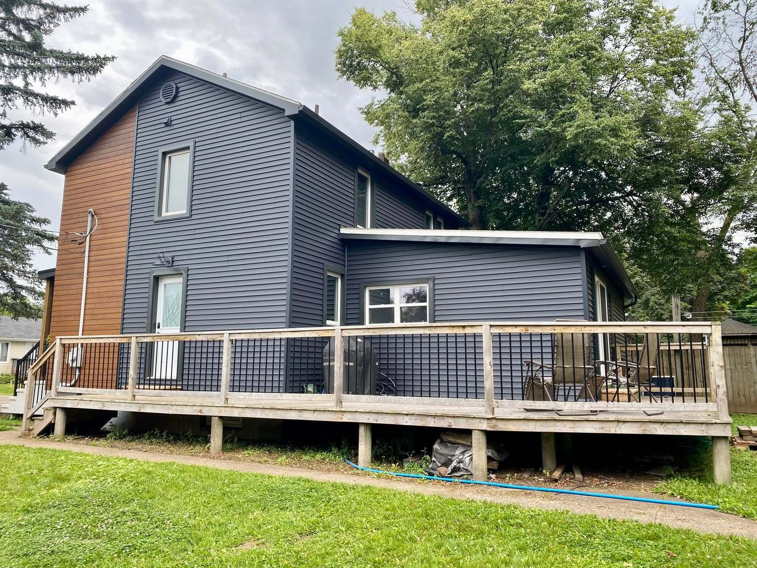 Renovated home exterior with new siding and deck